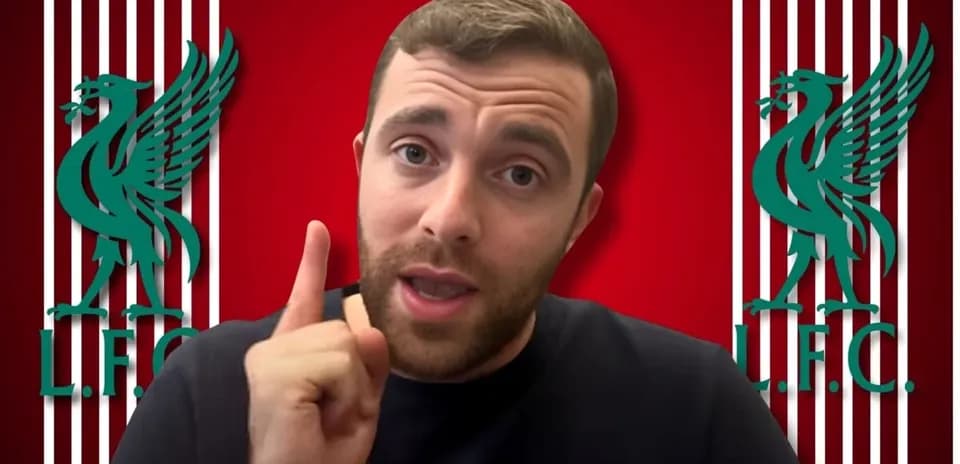 Человек на фоне логотипа Ливерпуля