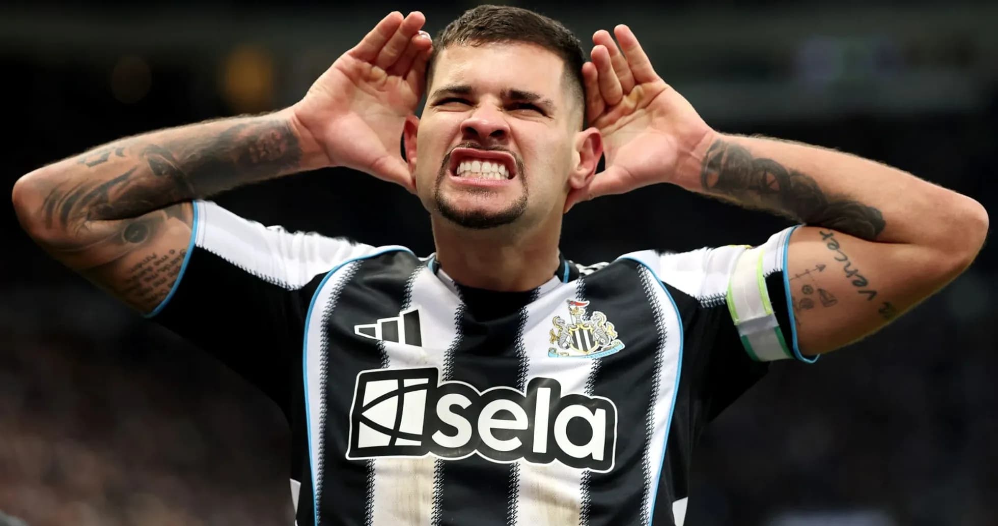 Игрок Newcastle United с руками у ушей на поле