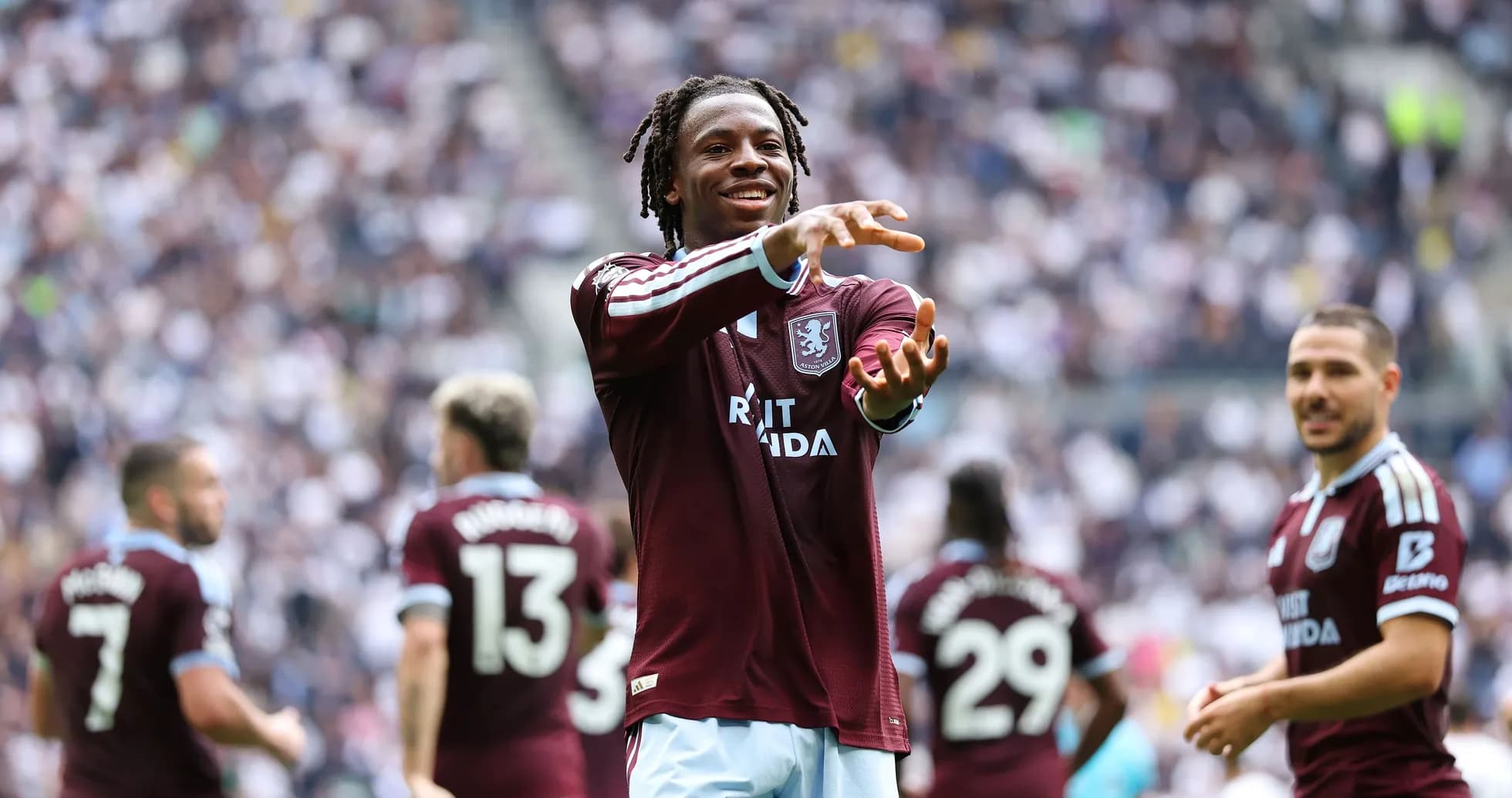 Игрок Aston Villa приветствует зрителей на стадионе