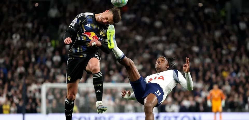 Goalkeeper and player colliding during football match