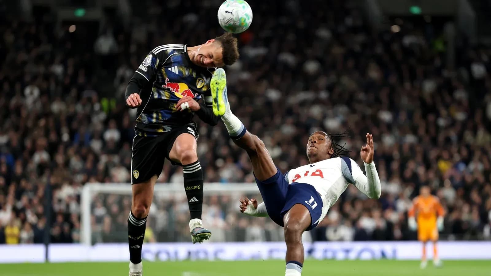 Goalkeeper and player colliding during football match