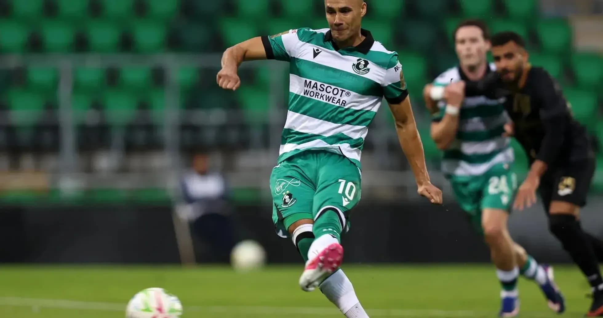 Игрок Shamrock Rovers выполняет удар по мячу Игрок Shamrock Rovers выполняет удар по мячу