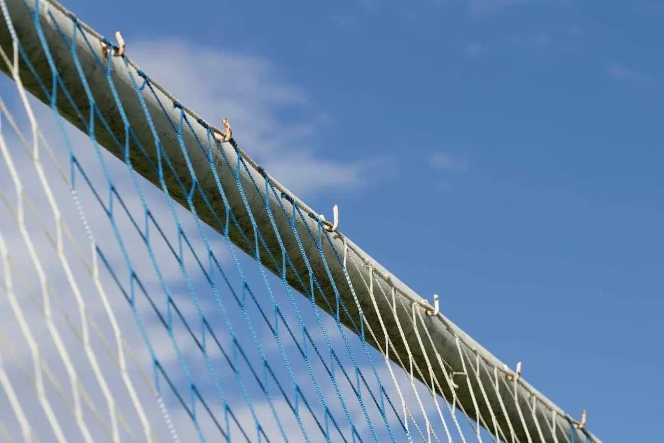 Close-up of goal net against blue sky Close-up of goal net against blue sky