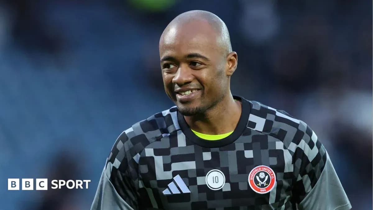 Вратарь в форме Sheffield United улыбается на поле Вратарь в форме Sheffield United улыбается на поле