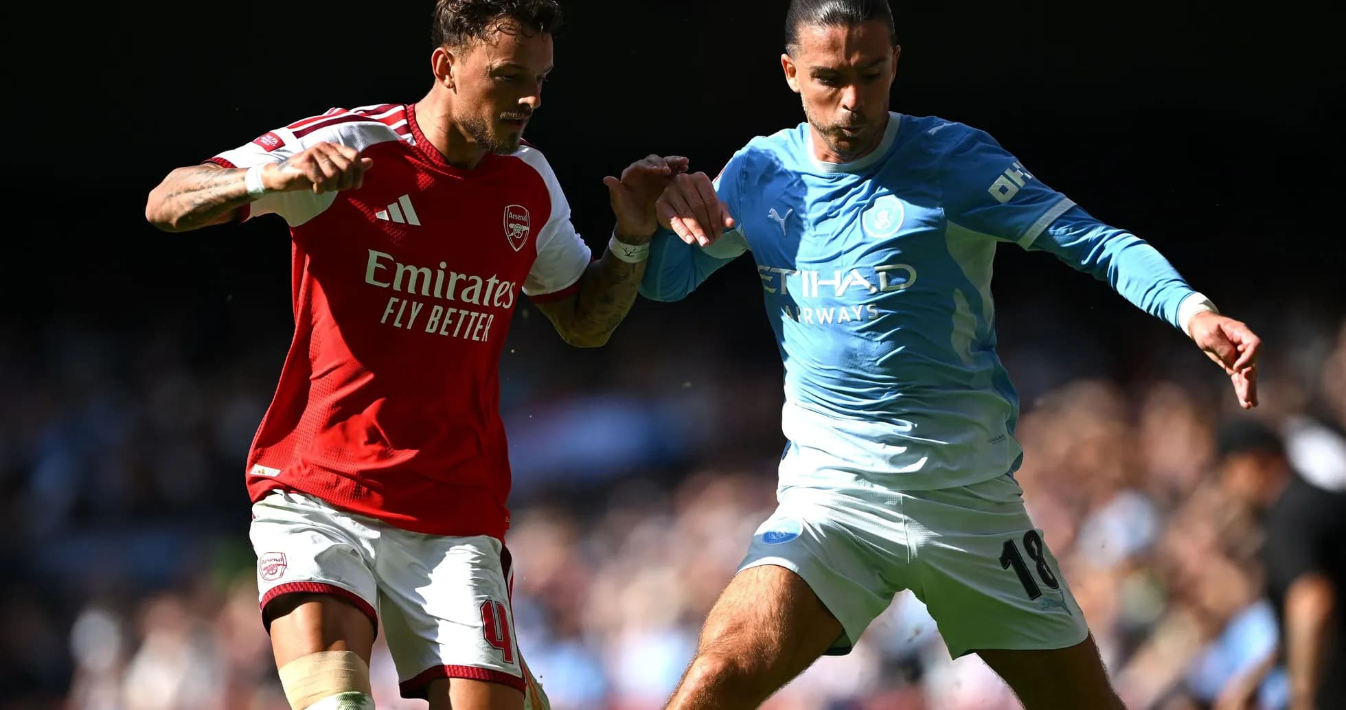 Игроки Arsenal и Manchester City борются за мяч Игроки Arsenal и Manchester City борются за мяч